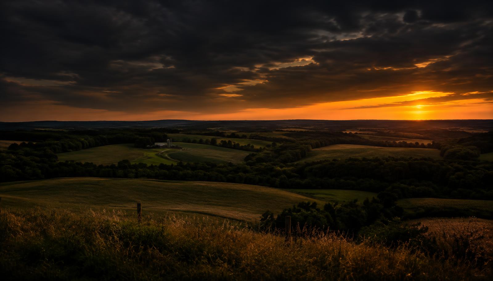 Rolling Mid-Missouri countryside hills at sunset under a dramatic sky